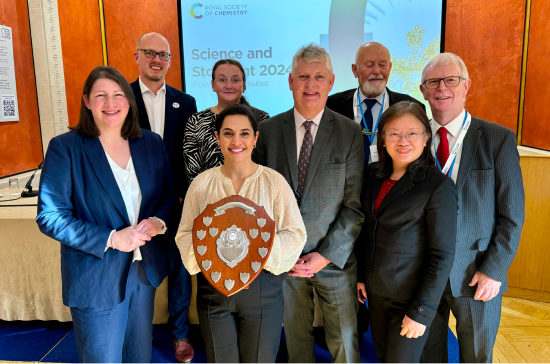 RSB NI Branch Outreach Champion awardee with her award, Dr Mark Downs, and panel